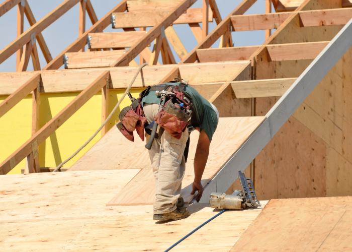 A worker performs commercial roof repair in Cranston.